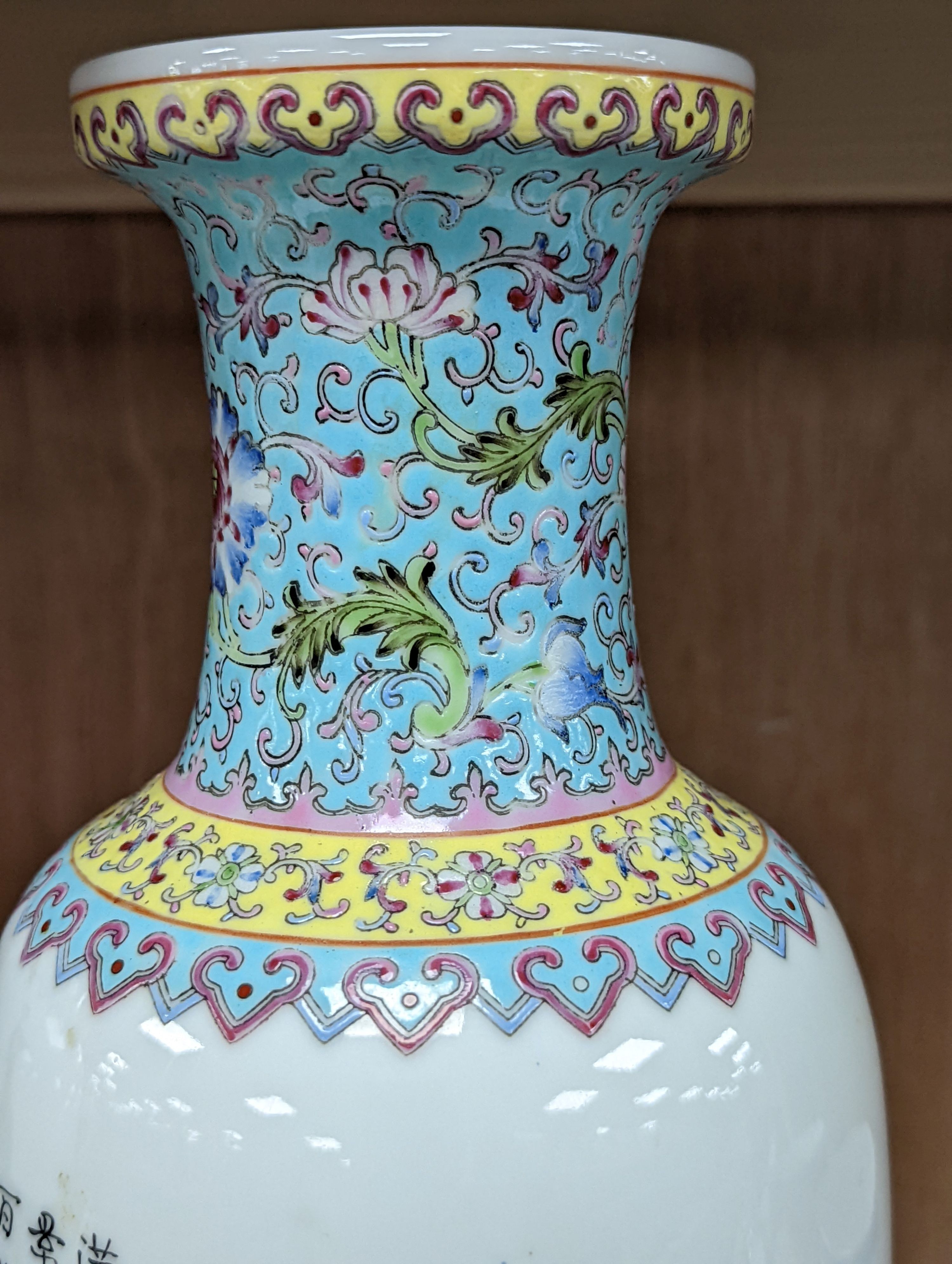 A pair of Chinese famille rose vases decorated with peacocks, 31cm